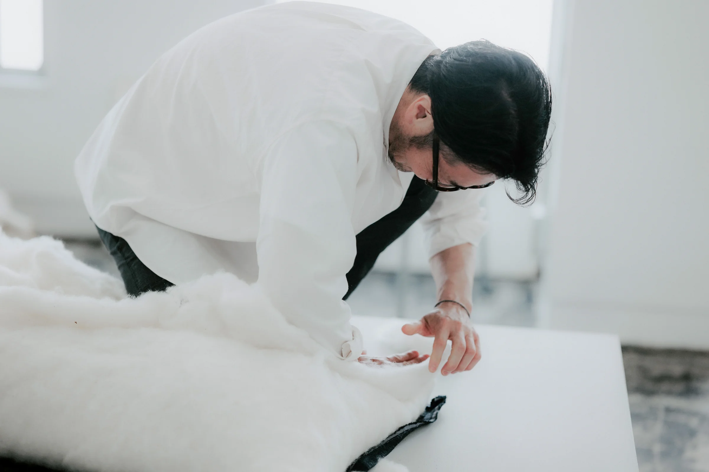 Takuya Niwa hand-tailoring a silk floss cushion