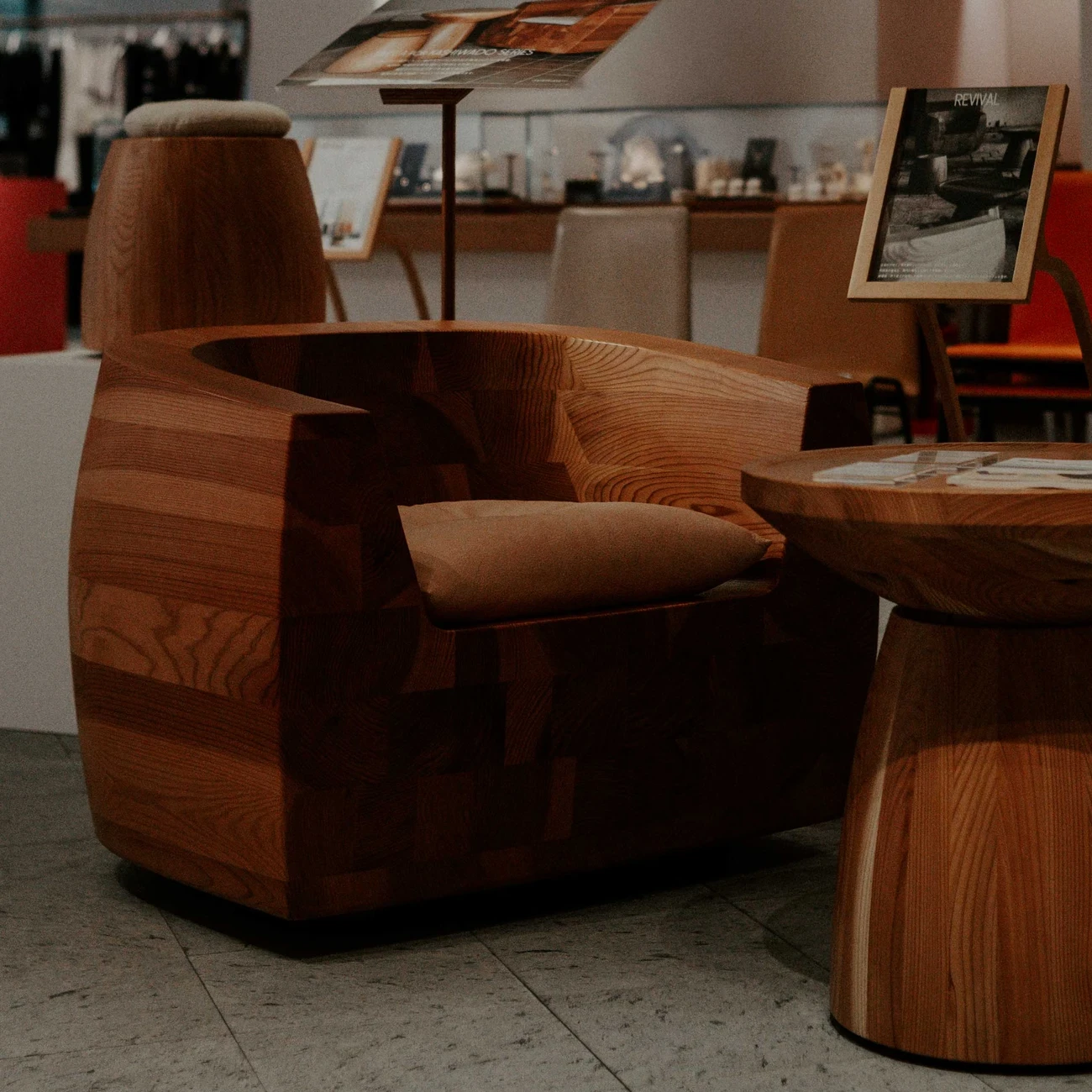 A wooden armchair with a cushion, made with a furniture workshop.