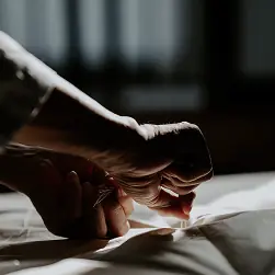 Hands hand-stitching a futon