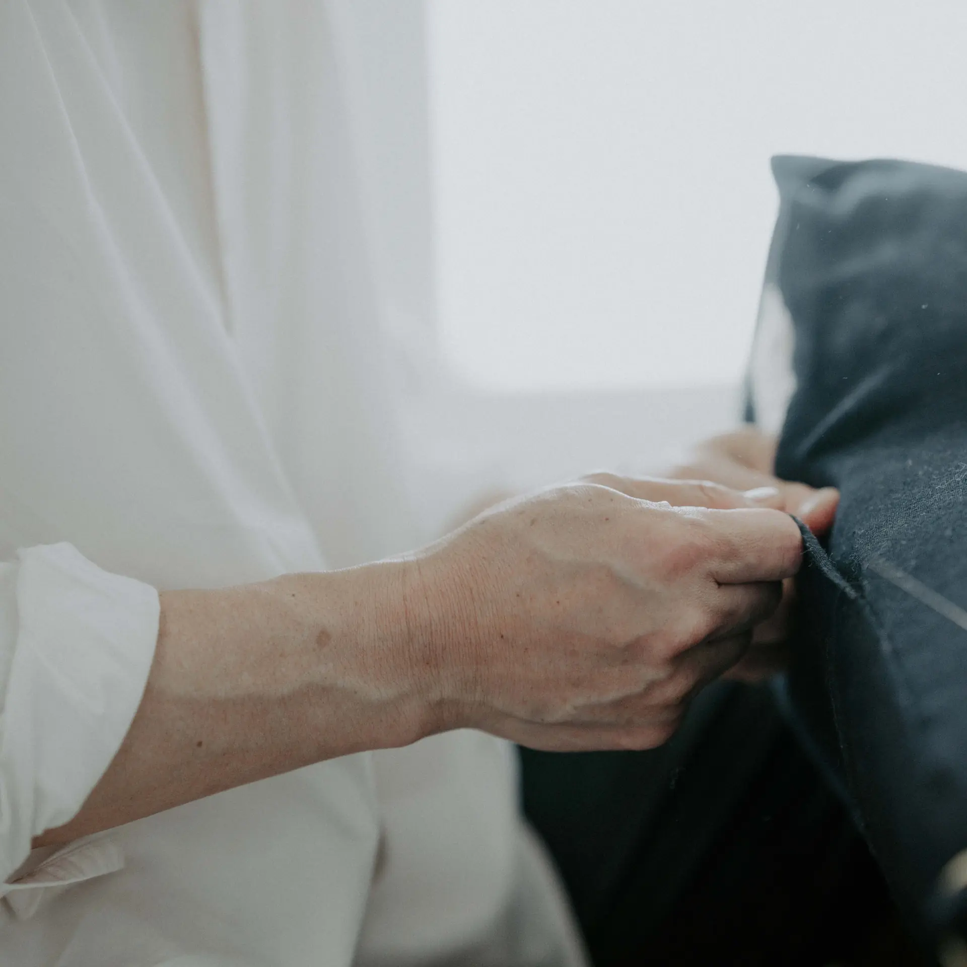 The folded cotton pressed into a corner by hand.